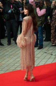 Dakota Johnson at the premiere in a Gucci golden dress